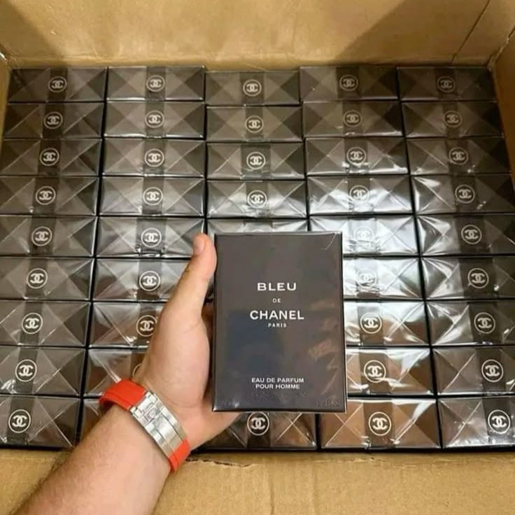 Box containing 50 original designer perfumes, all customer returns offered at a discounted price