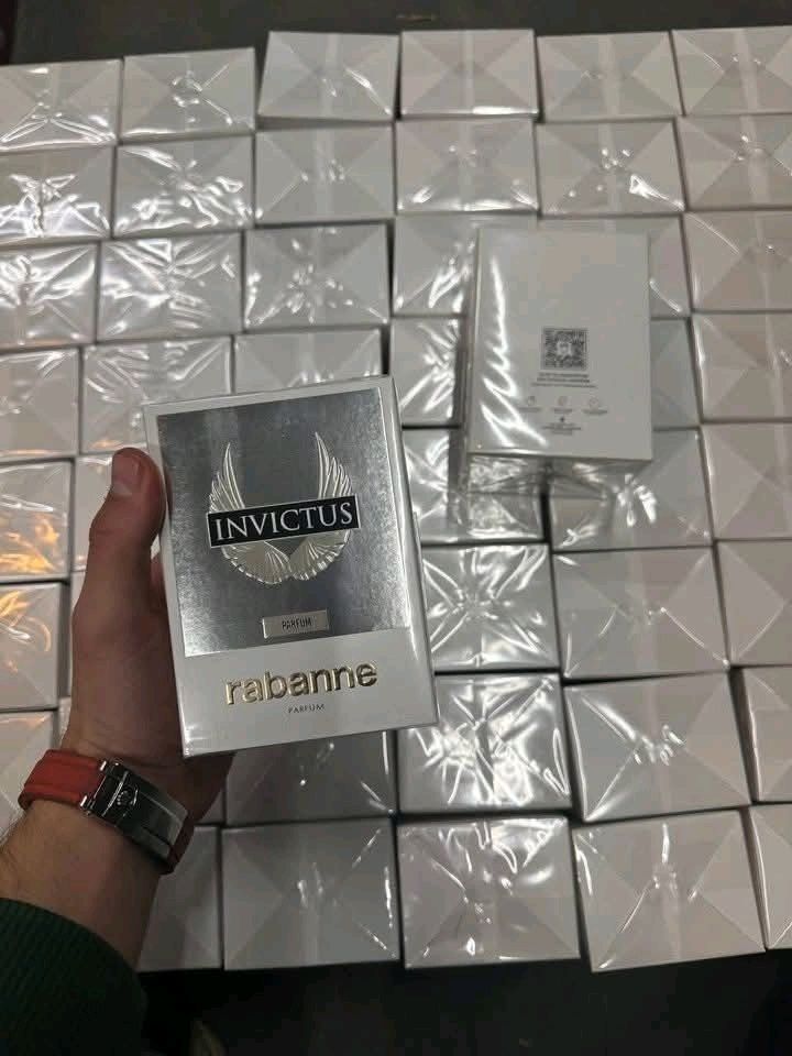Box containing 50 original designer perfumes, all customer returns offered at a discounted price